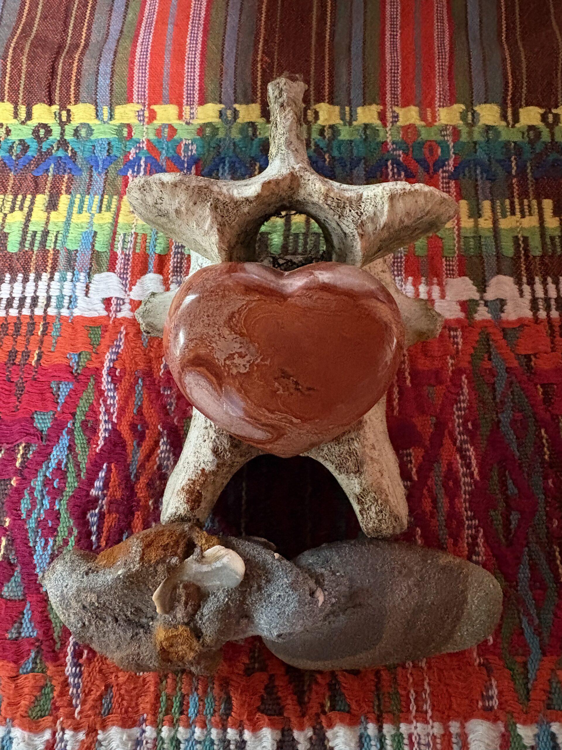 A grief-tending altar with candles, flowers and offerings